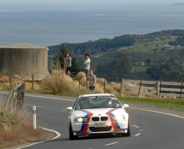 Australians Adam Kaplan and Alesia Penney take a corner on Saddle Hill Rd, above Brighton, in their BMW M3 CSL during the Targa Rally yesterday. Photo: John Fridd