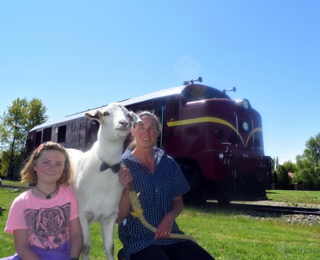 Jo Koppert and her daughter Jeska Koppert (10), of Middlemarch, and their goat Eddy attend a street party in Middlemarch on Sunday. Photo: Shawn McAvinue