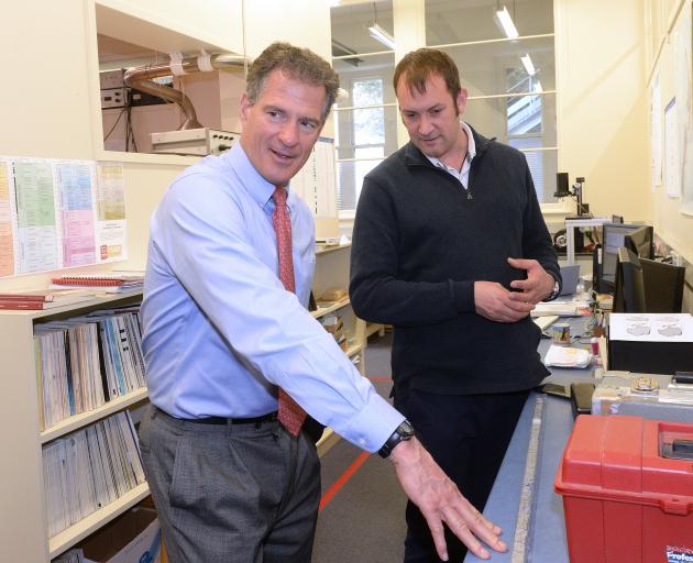 United States ambassador Scott Brown (left) discusses an Antarctic core sediment sample with University of Otago Geology Department research scientist Dr Christian Ohneiser. Photo: Linda Robertson