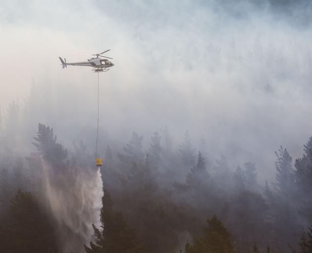 Four helicopters used monsoon buckets to fight the blaze. Photo: Andy Cole