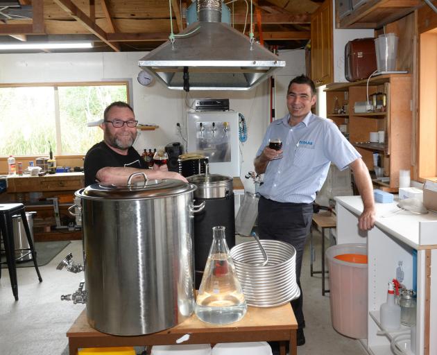 Mosgiel brewers Brett Houliston and Jimmy Henderson raise their prize-winning brew. PHOTO: LINDA...