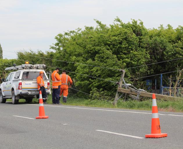 Crews respond to damaged power lines after a single-vehicle accident on the Dipton-Winton Highway yesterday. Photo: Ben Waterworth