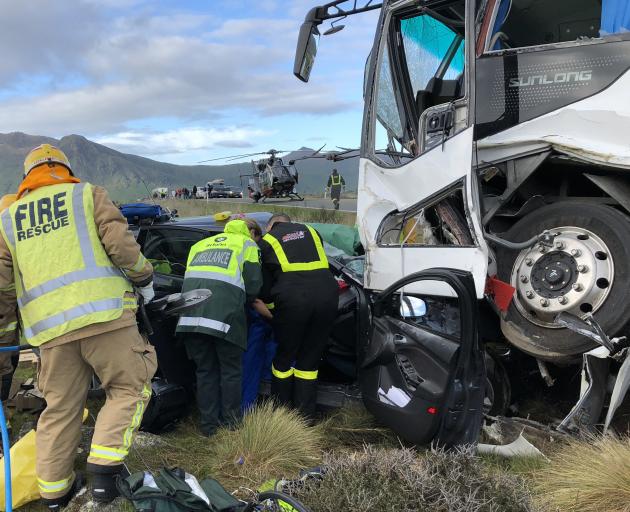 Emergency services staff work at the scene of a fatal collision near Kingston yesterday. Photo:...