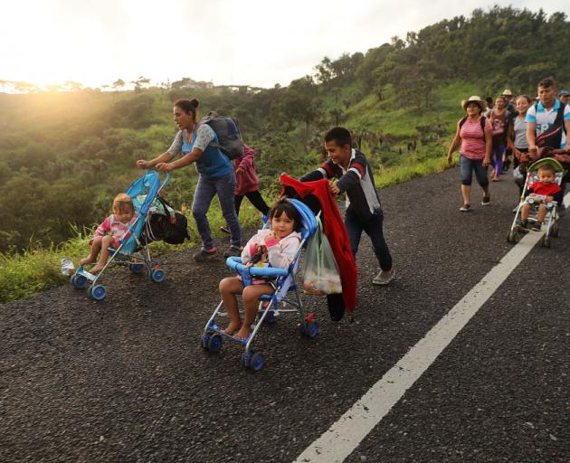 Members of the Central American migrant caravan move to the next town in Matias Romero, Mexico. Photo: Getty Images