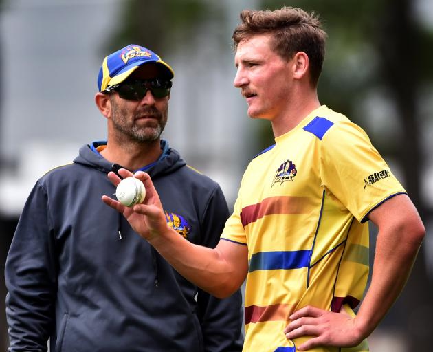  Otago coach Rob Walter gives all-rounder Nathan Smith a few instructions during a training...