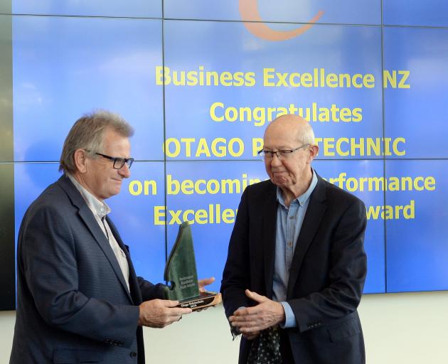 Otago Polytechnic chief executive Phil Ker (left) receives the performance excellence award from...
