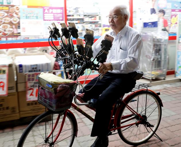 The pensioner said he sometimes plays all night thanks to the custom-made portable battery packs that recharge the phones. Photo: Reuters The pensioner said he sometimes plays all night thanks to the custom-made portable battery packs that recharge the phones. Photo: Reuters