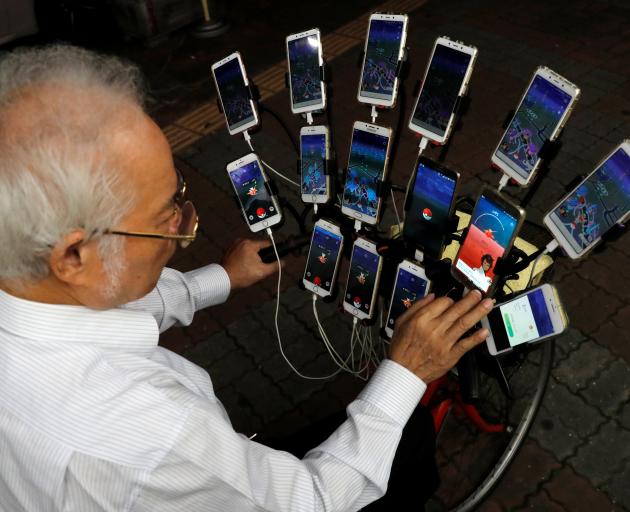 Taiwanese Chen San-yuan, known as "Pokemon grandpa", plays the mobile game "Pokemon Go" by Nintendo. Photo: Reuters Taiwanese Chen San-yuan, known as "Pokemon grandpa", plays the mobile game "Pokemon Go" by Nintendo. Photo: Reuters