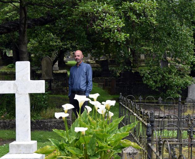 Dunedin Budget Advisory Service executive officer Andrew Henderson inspects graves in the Southern Cemetery in Dunedin on Monday.  Photo: Shawn McAvinue