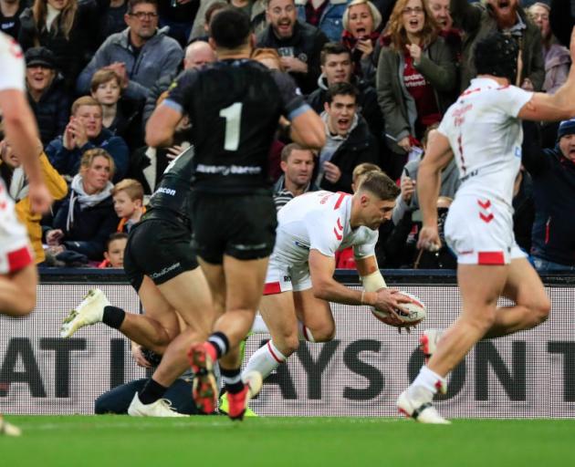 England's Tommy Makinson scores against the Kiwis in the second half at Anfield. Photo: Getty Images