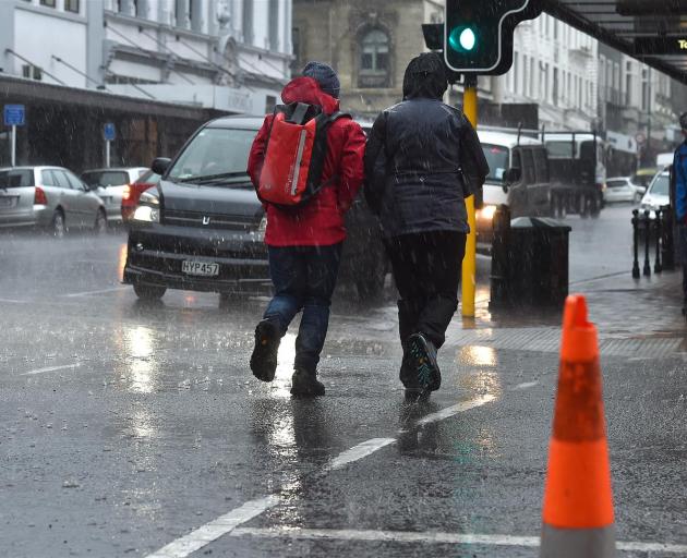 Heavy rain hits Stuart St as a front moves over Dunedin yesterday. 