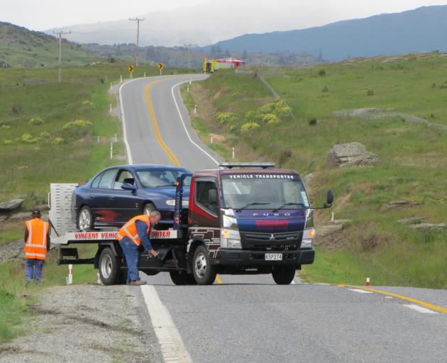 A tow truck prepares to take away a car which ran of the road this morning between Butcher's Dam...