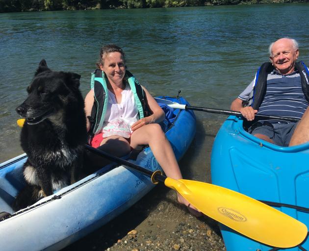 Glenys Ivory, of Alexandra, and her father Huon Rodway, of Hobart, rest with Jaffa the dog after kayaking on the Clutha River near Alexandra on Christmas Day. Photo: Pam Jones