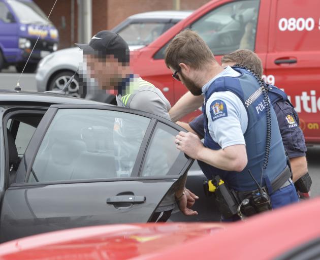 Police arrest a man after he evaded police at a checkpoint in Dunedin yesterday afternoon. Photo: Gerard O'Brien