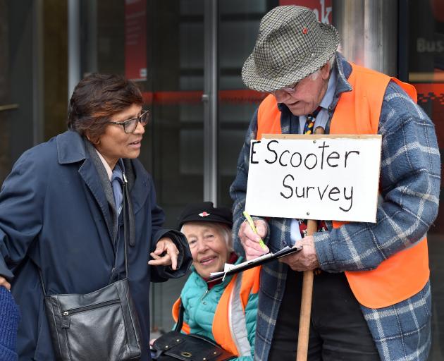 Signing a survey on e-scooters in George St late last week is Dunedin resident Maureen Pearson (left), while talking the survey's authors, Jim and Beth Moffat. Photo: Peter McIntosh
