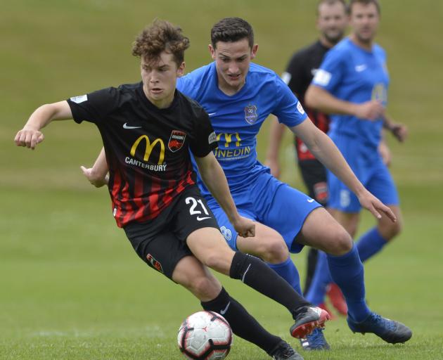 Canterbury United’s Seth Clark is in possession of the ball as Southern United’s Tony Whitehead...