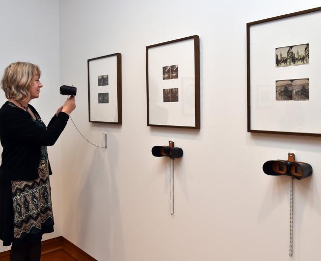 Hocken photography curator Dr Anna Petersen looks through a new hand-crafted stereoscope the library has imported from America to look at its stereoscope images. Photo: Gregor Richardson