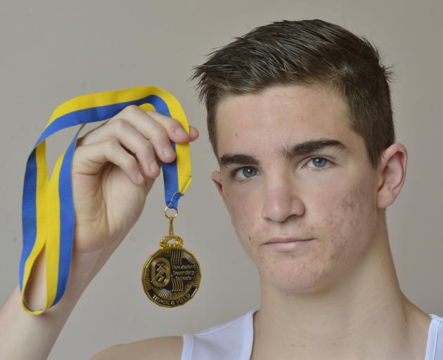 John McGlashan College's Shay Veitch with the gold medal he won with a personal best leap in the senior boys' long jump at the national secondary school athletics championships at the Caledonian Ground on Sunday. Photo: Gerard O'Brien