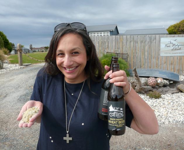 Port Molyneux School owner Jade McNab says its new bottle crusher is helping the Kaka Pt event venue reduce its load on the environment. Photo: Richard Davison