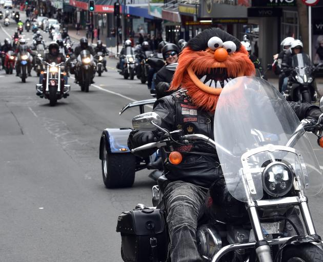 Phil Herriott, of Dunedin, wears his  Muppet helmet as he rides his Harley-Davidson into the...