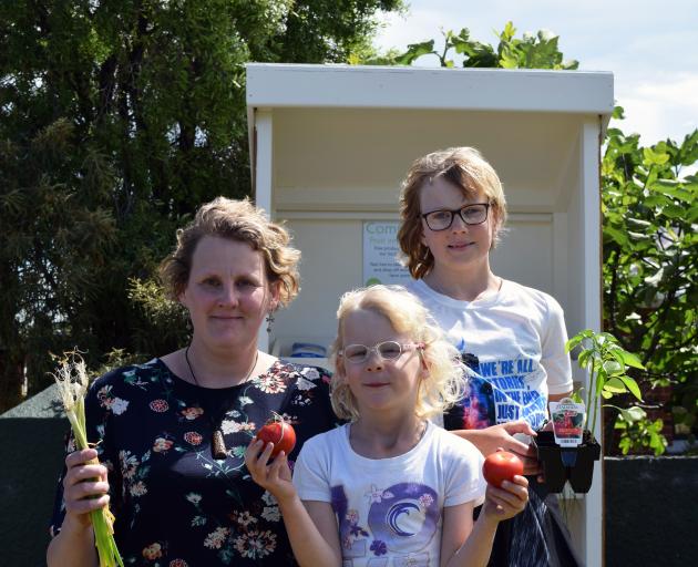 Displaying some of the produce in a community fruit and vegetable stand in Waldronville on Monday are (from left) Saddle Hill Community Board deputy chairwoman Leanne Stenhouse and her daughters Mia (6) and Amy Smith (11). Photo: Shawn McAvinue Displaying some of the produce in a community fruit and vegetable stand in Waldronville on Monday are (from left) Saddle Hill Community Board deputy chairwoman Leanne Stenhouse and her daughters Mia (6) and Amy Smith (11). Photo: Shawn McAvinue