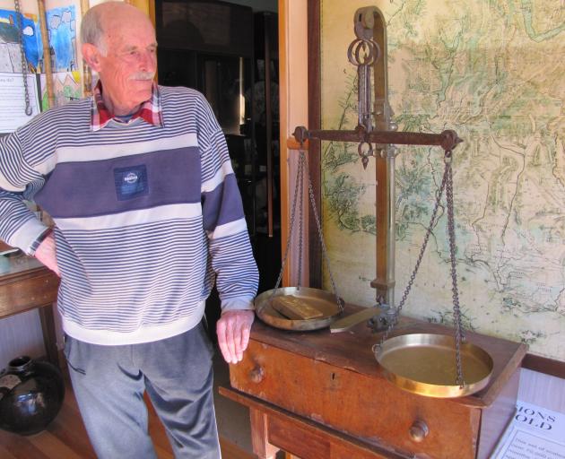 Clyde Museum curator John Hanning looks over the museum's 1862 gold scales and 1866 map of Otago and Southland gold claims. Photos: Pam Jones