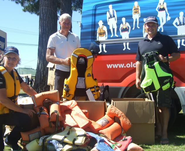 Helping boat users upgrade their old lifejackets are (from left) Sue Tucker, Shayne Hitchcock and...