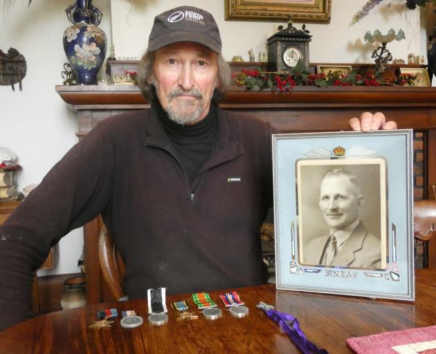 Alex Holms, nephew of Flight Sergeant Alexander Hunter Holms, with his uncle's photo and medals....