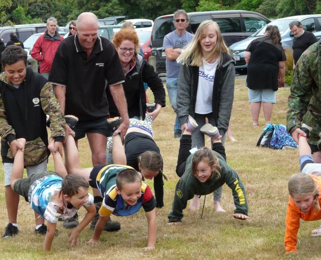 Participants in the wheelbarrow race at the Papatowai Beach Carnival on New Year's Eve.