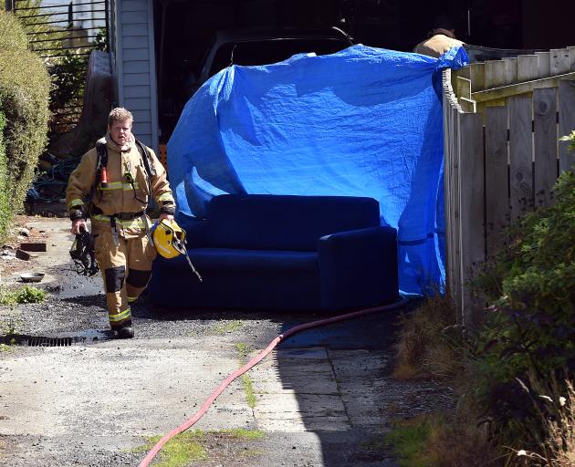 A Fire and Emergency officer at the scene where the car was alight. Photo: Peter McIntosh A Fire and Emergency officer at the scene where the car was alight. Photo: Peter McIntosh