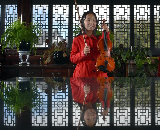 Young violinist Justine Hua practises Baroque masterpieces at the Chinese Gardens yesterday....