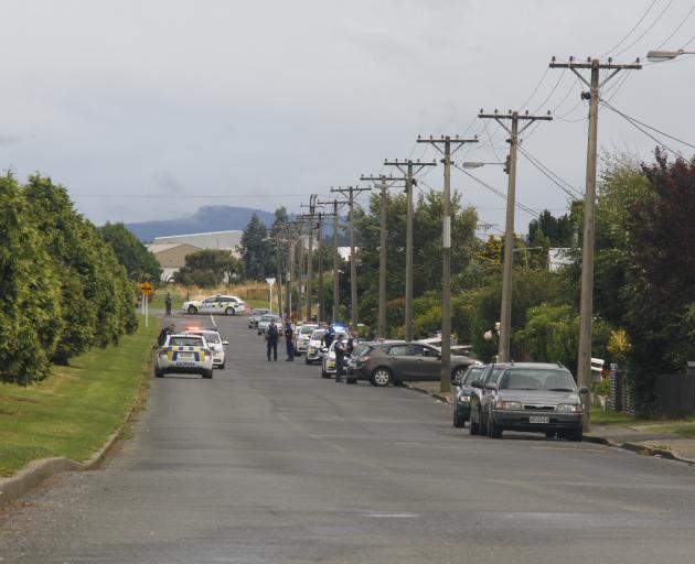 Police stand guard outside a house in Drury Lane in Invercargill's Grasmere suburb where there...