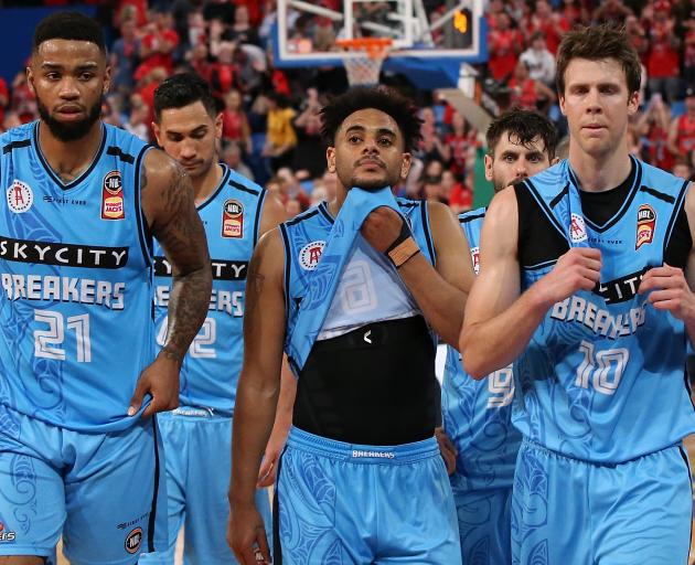 Shawn Long, Corey Webster and Thomas Abercrombie of the Breakers look dejected as they walk off...