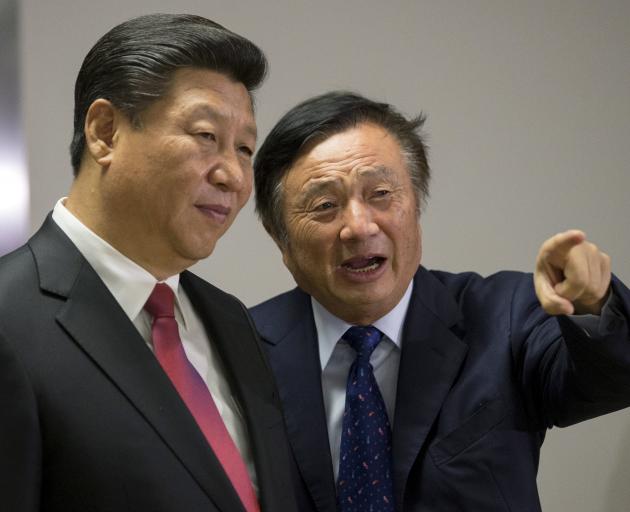 Chinese President Xi Jinping pauses as he is shown around the offices of Huawei Technologies Co...