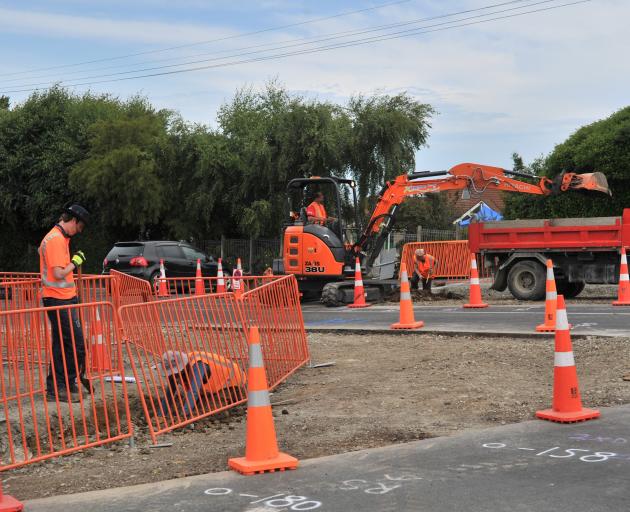 Contractors work on a roundabout and other safety improvements at the intersection of Brown St...