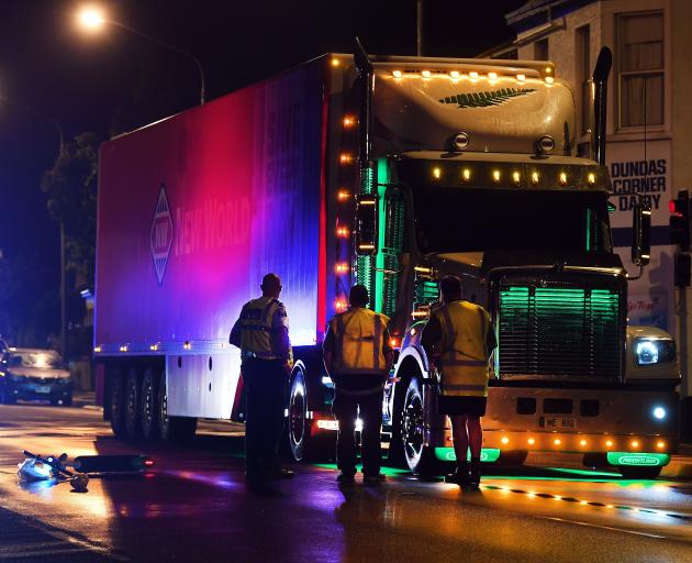 Police talk to a truck driver following an accident involving a truck and a Lime scooter in...