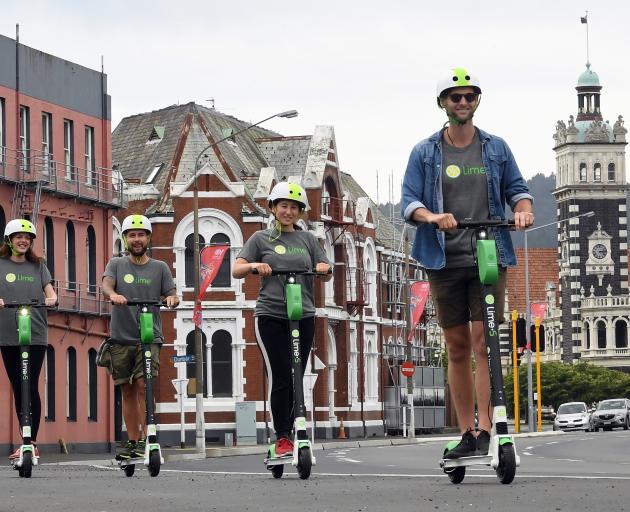 Taking the Lime e-scooters for a spin down the Cumberland St shared cycle path before the launch of the service in Dunedin today are Lime city launcher (front right) Matt McNeill and employees Elena Khoo, James Samme and Ellie Fanning. Photo: Stephen Jaqu