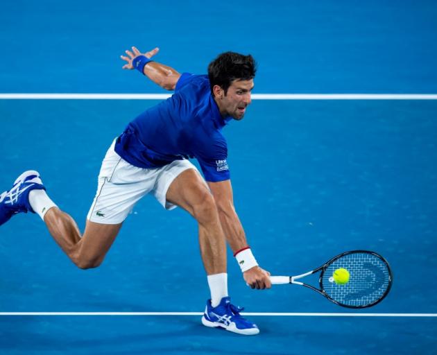Novak Djokovic reaches to play a backhand during his second round win last night in Melbourne....