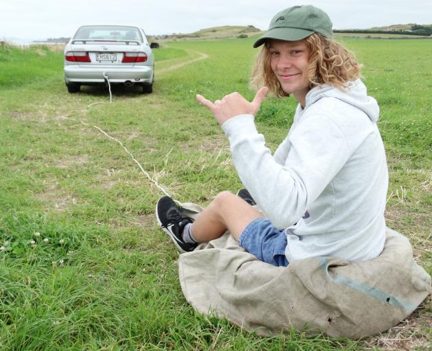 Patrick Ens gets set for some grass surfing at his family's Kakanui property yesterday. The 19-year-old and his brother created the pastime to add some excitement to the school holidays. Photo: Daniel Birchfield