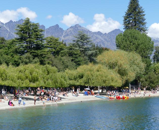 Hundreds of people make the most of balmy temperatures in Queenstown Bay last month. Photo:...