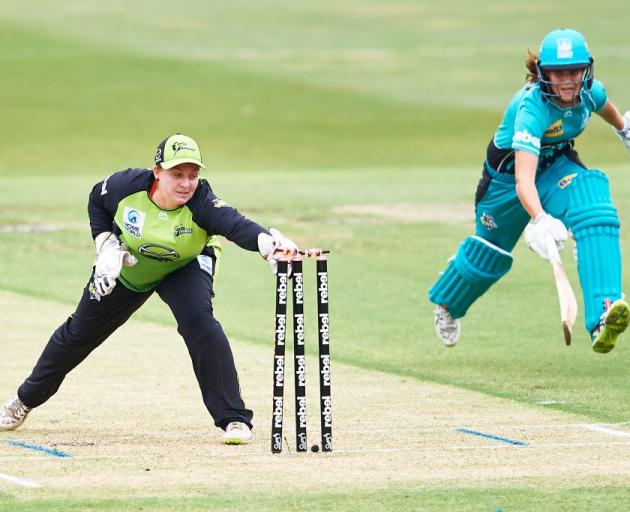 Rachel Priest playing for the Sydney Thunder runs out the Brisbane Heat's Josie Dooley in the...