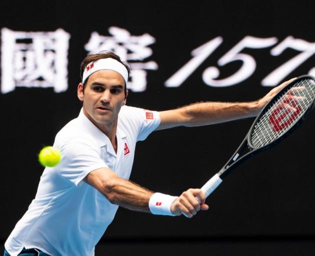 Roger Federer plays a backhand during his second round win at the Australian Open yesterday....