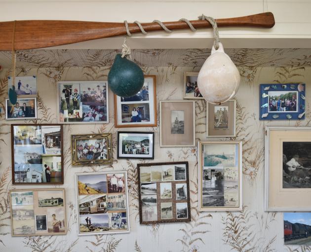 The crib's interior is filled with an assortment of family photos and old knick-knacks carefully...
