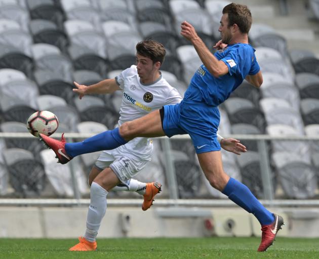 Southern United defender Erik Panzer gets across to clear the ball from Team Wellington’s Jack...