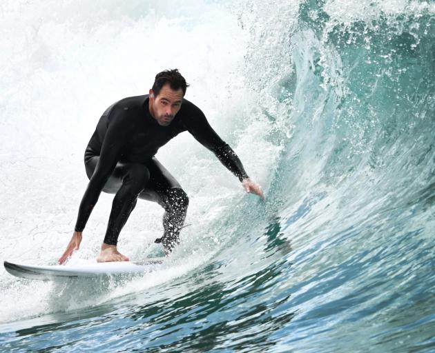 Will Lewis, of Dunedin, enjoys surfing at St Clair Beach yesterday. PHOTO: GERARD O'BRIEN