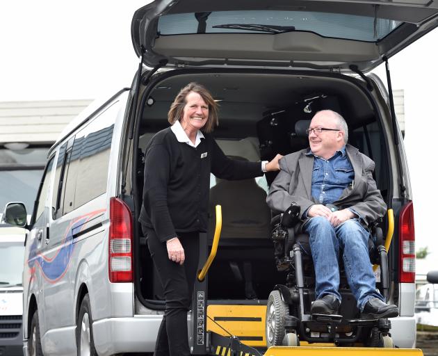 Southern City Taxis driver Julie Manson helps Chris Ford in to one of the company's total...