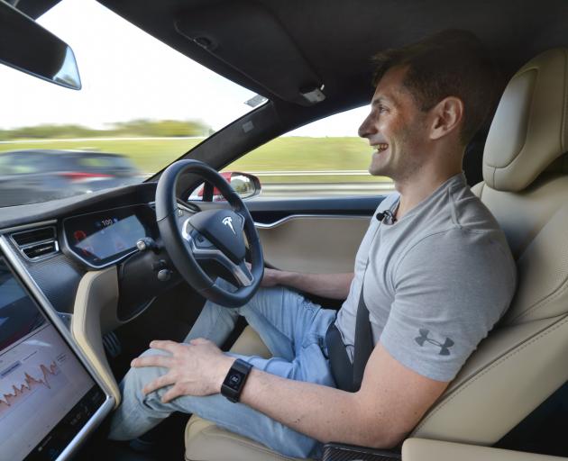 Rockertwerkz founder Dean Hall enjoys a handsfree moment in his Tesla. Photo: ODT files 