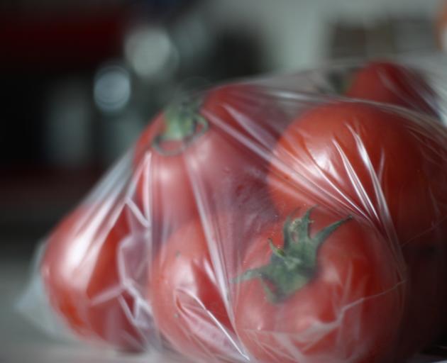 Close-Up Of Tomatoes In Plastic Bag. Photo: Getty Images