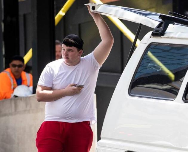 English tourist, who gave the name, John Johnson, leaves an Auckland hotel on Monday afternoon...