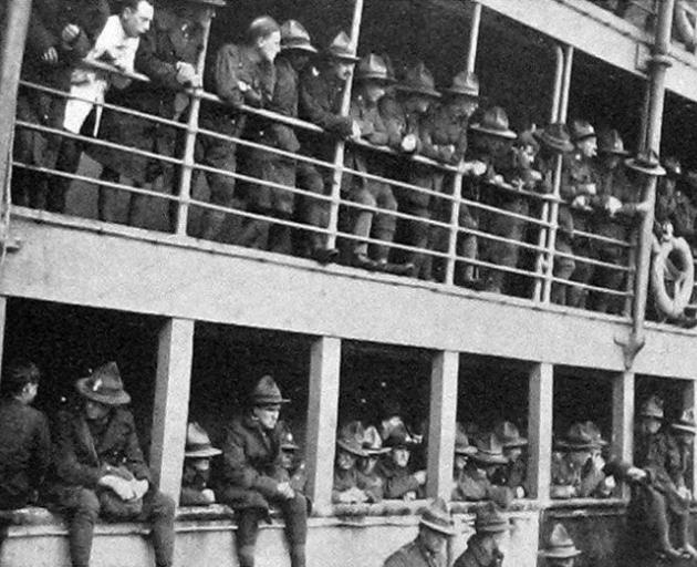 Returning soldiers line the railings on the Tahiti, awaiting their turn to disembark at Port...